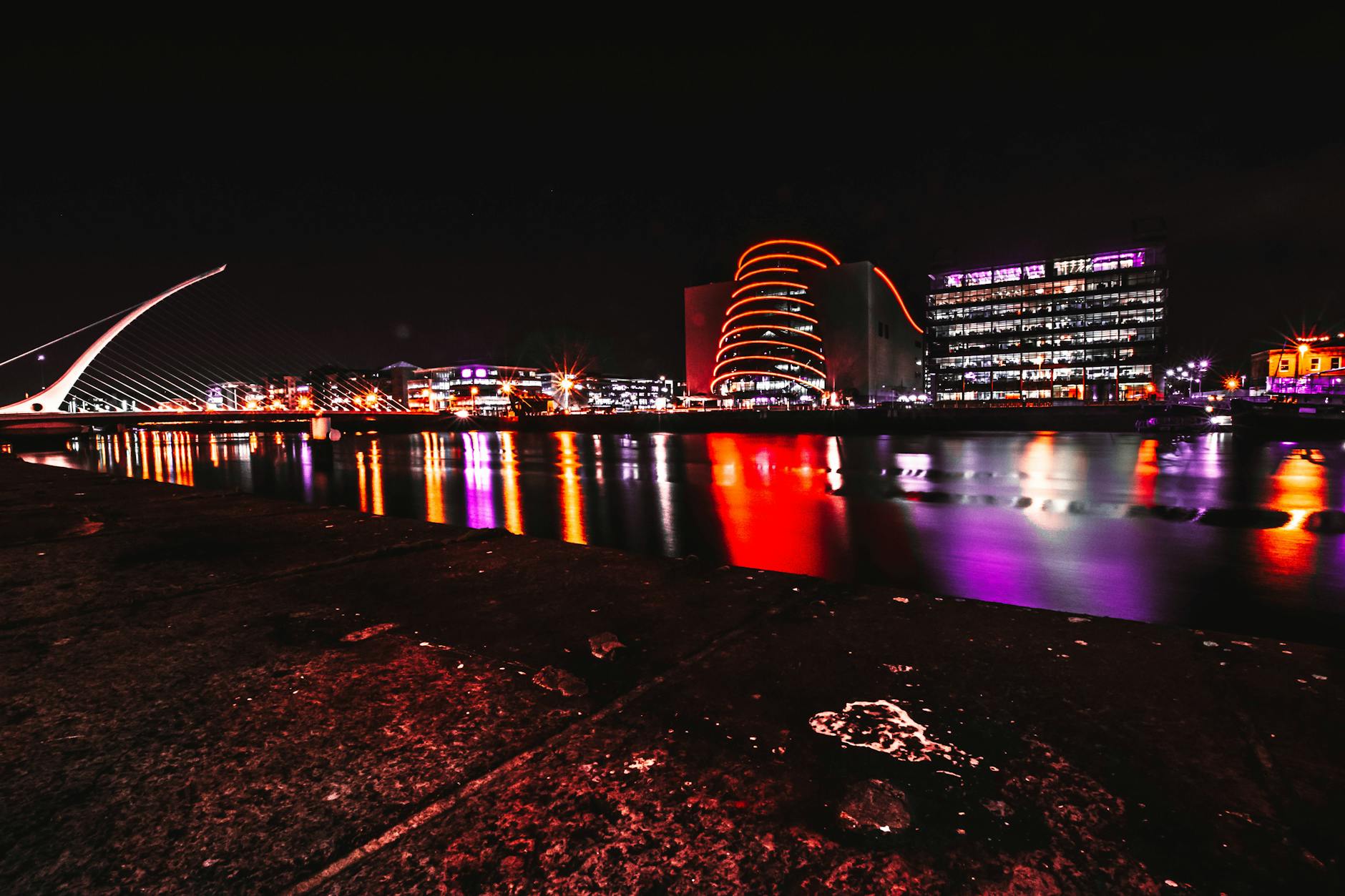 Dublin city illuminated at night with reflections on the River Liffey