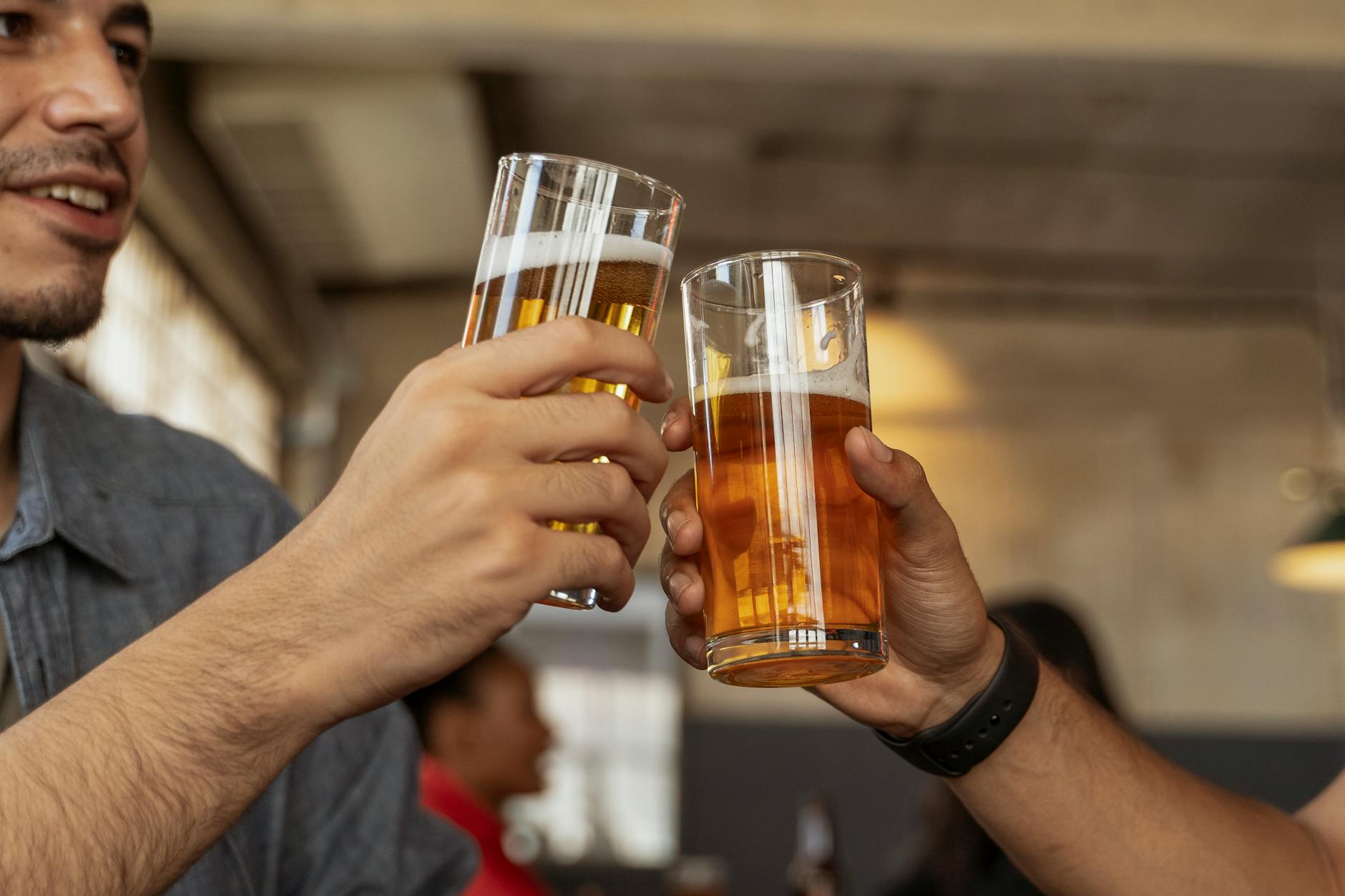 Friends raising pints in a lively Dublin pub