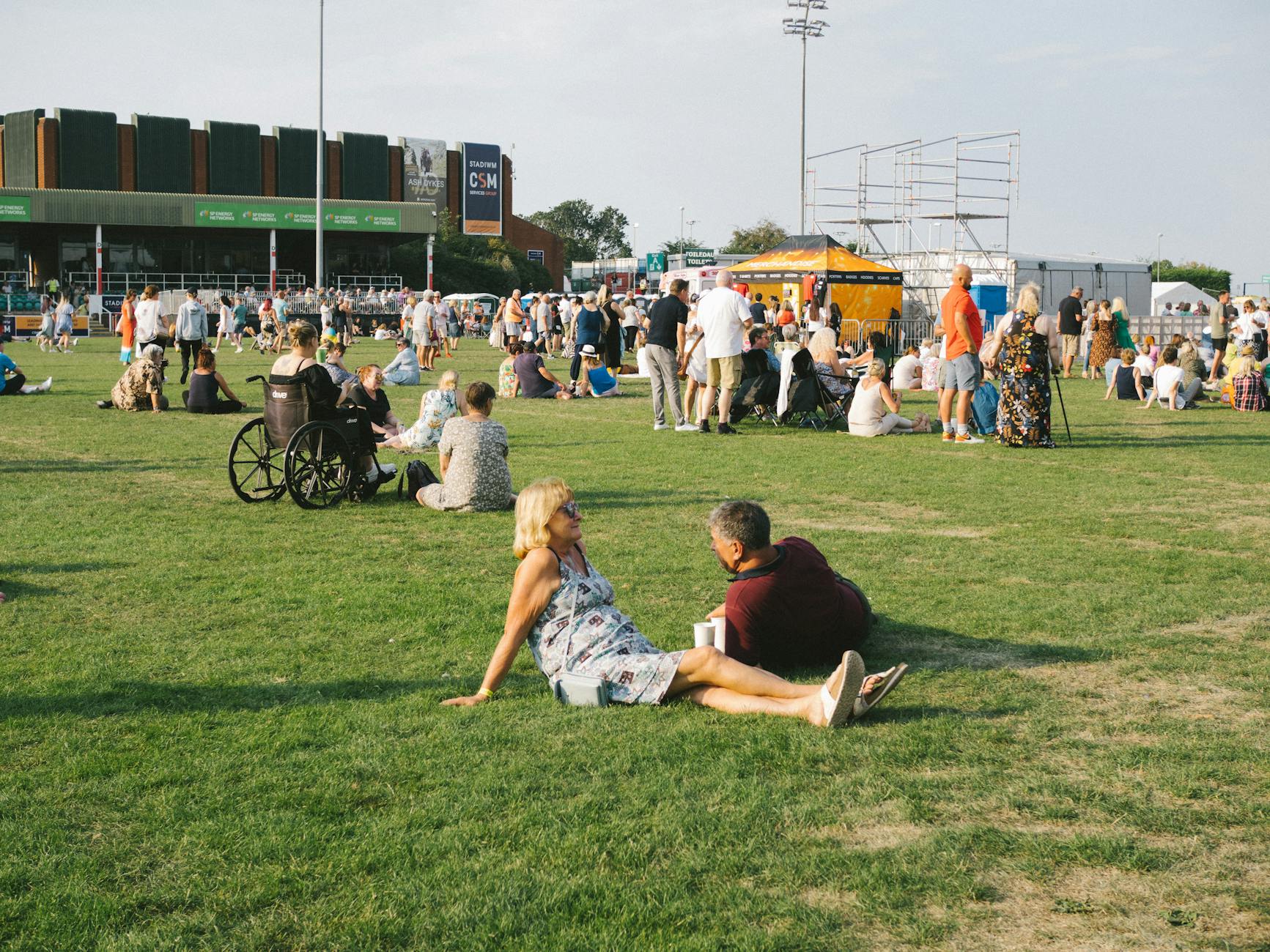 People enjoying a sunny summer outdoor event