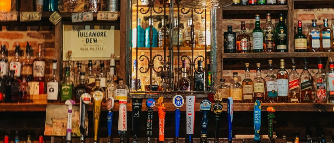 Cosy traditional Irish pub interior with a warm fire and wooden bar
