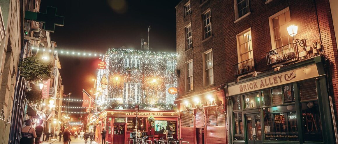 Dublin street lit up on a winter evening with Georgian buildings and Christmas lights