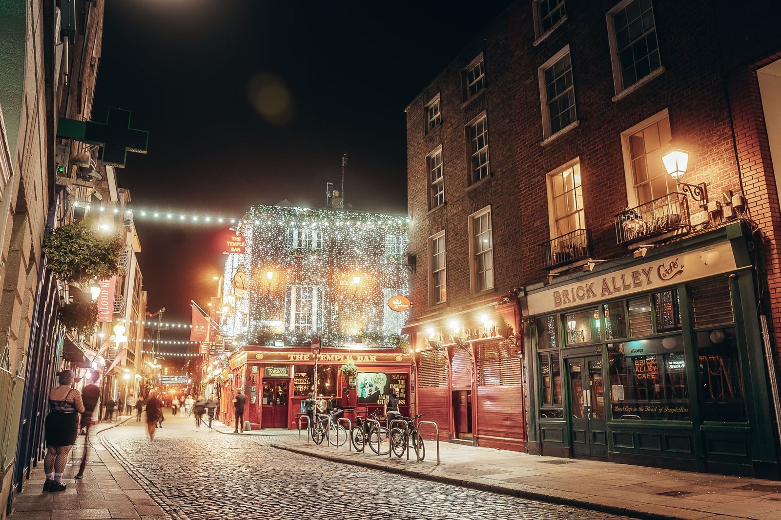 Dublin street lit up on a winter evening with Georgian buildings and Christmas lights