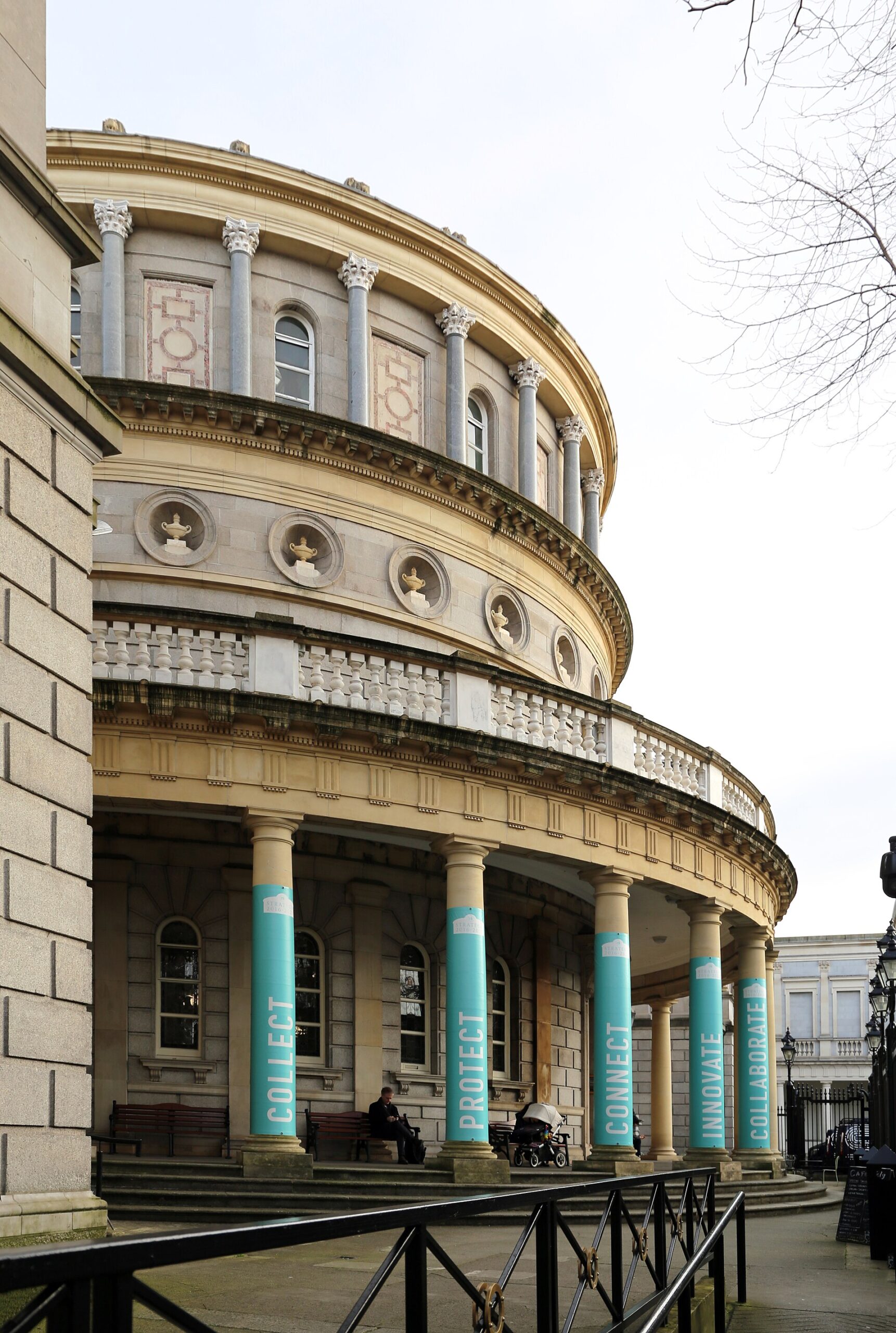 Columns and tall arched windows curve around the National Library of Ireland entrance in Dublin.