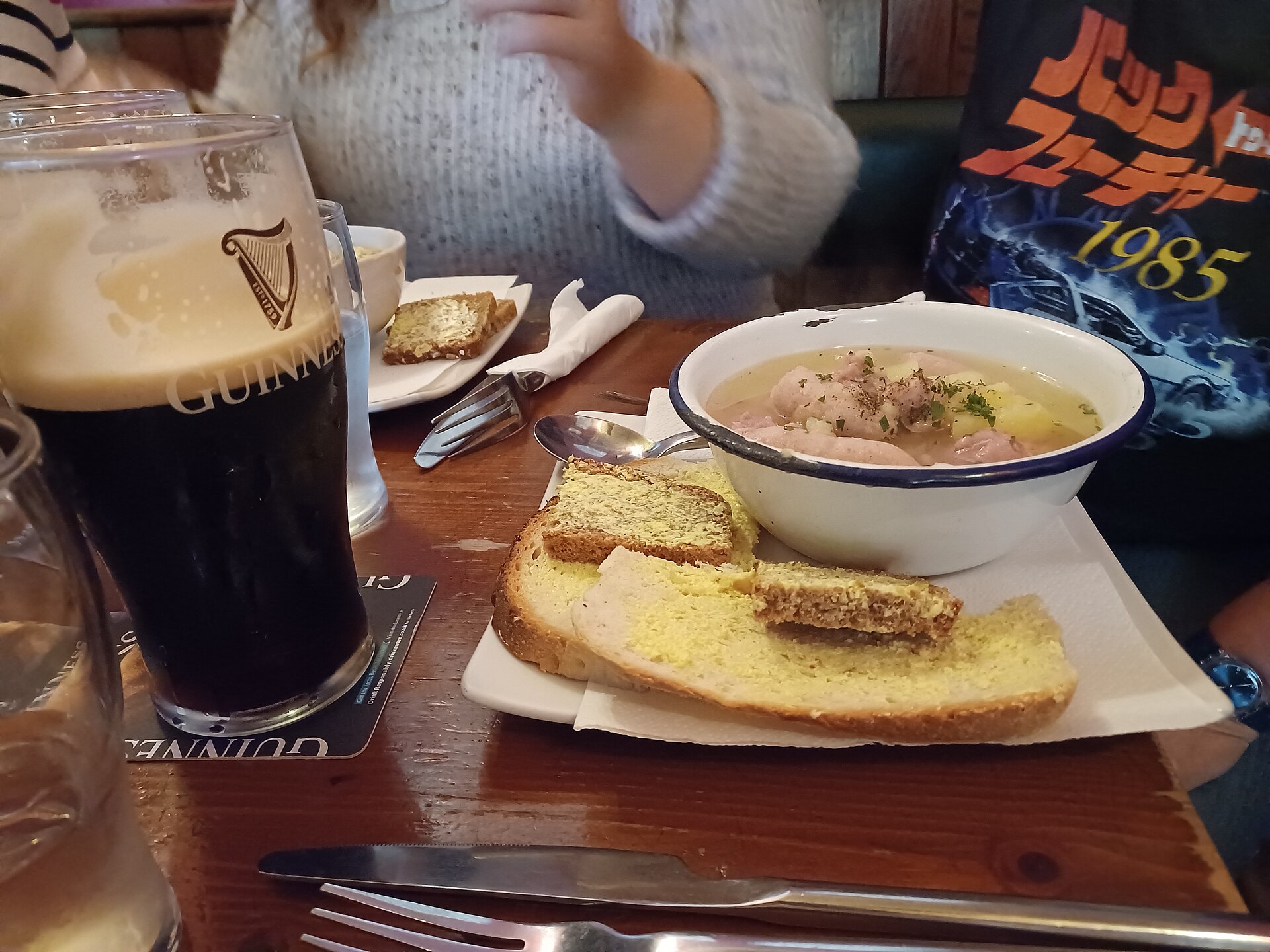 Dublin coddle with sausages and potatoes, buttered bread and a pint of Guinness at the Gravediggers pub in Dublin.