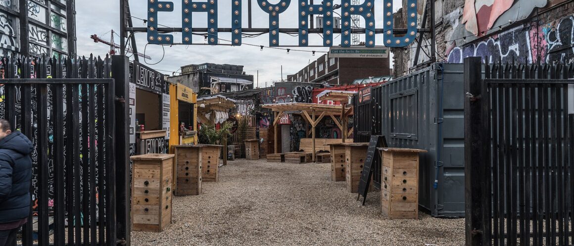 Eatyard's South Richmond Street courtyard in Dublin in 2017, with wooden standing tables and food stalls beneath a large sign.