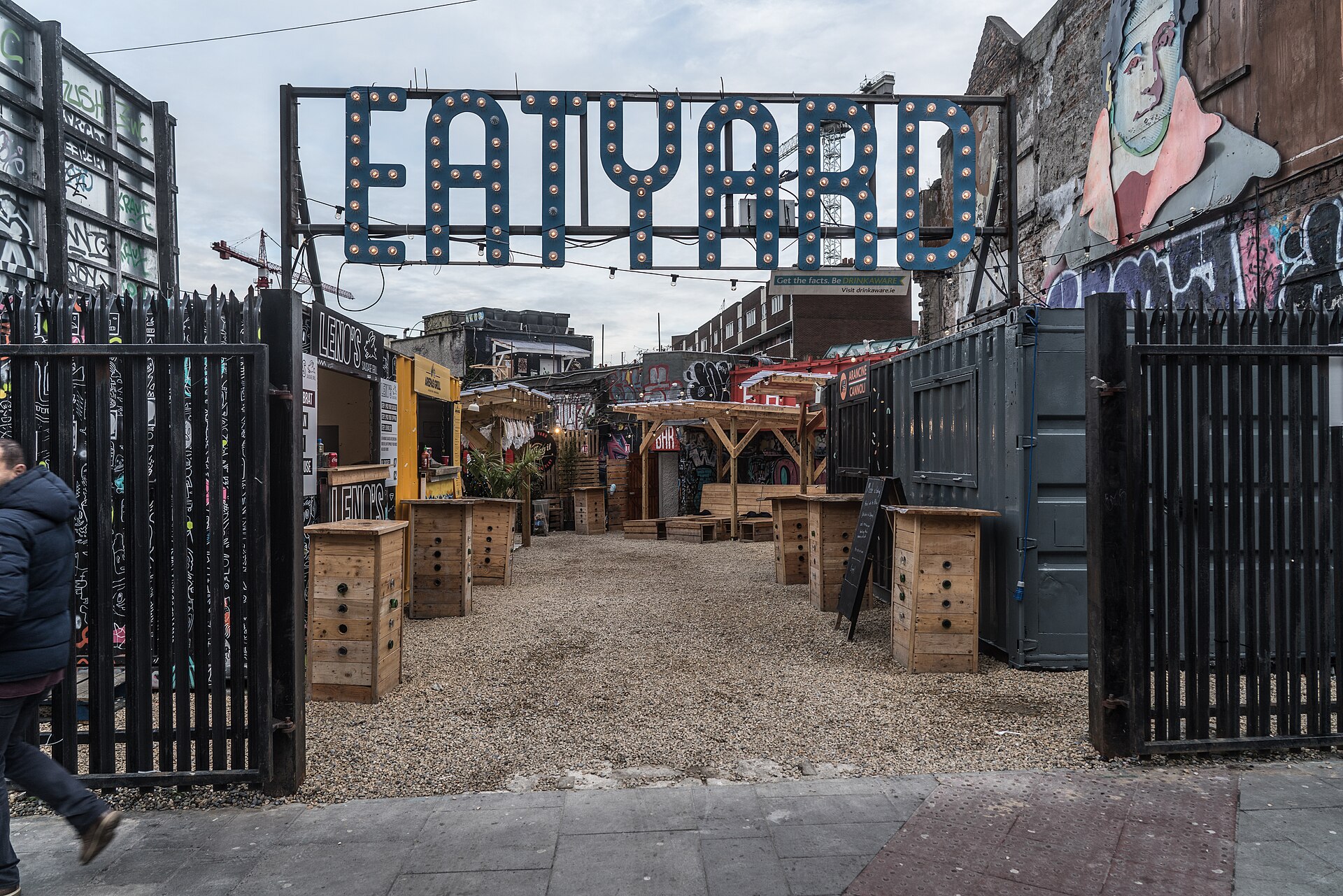 Eatyard's South Richmond Street courtyard in Dublin in 2017, with wooden standing tables and food stalls beneath a large sign.