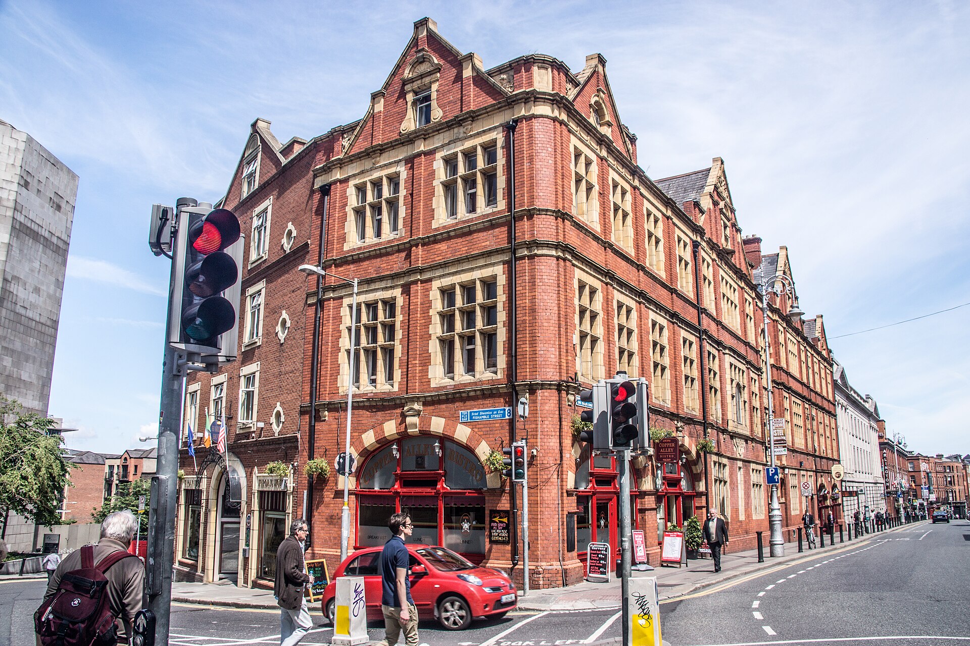 Kinlay House hostel in Dublin occupies a red-brick corner building with stone-trimmed windows, gables and red arched doorways.