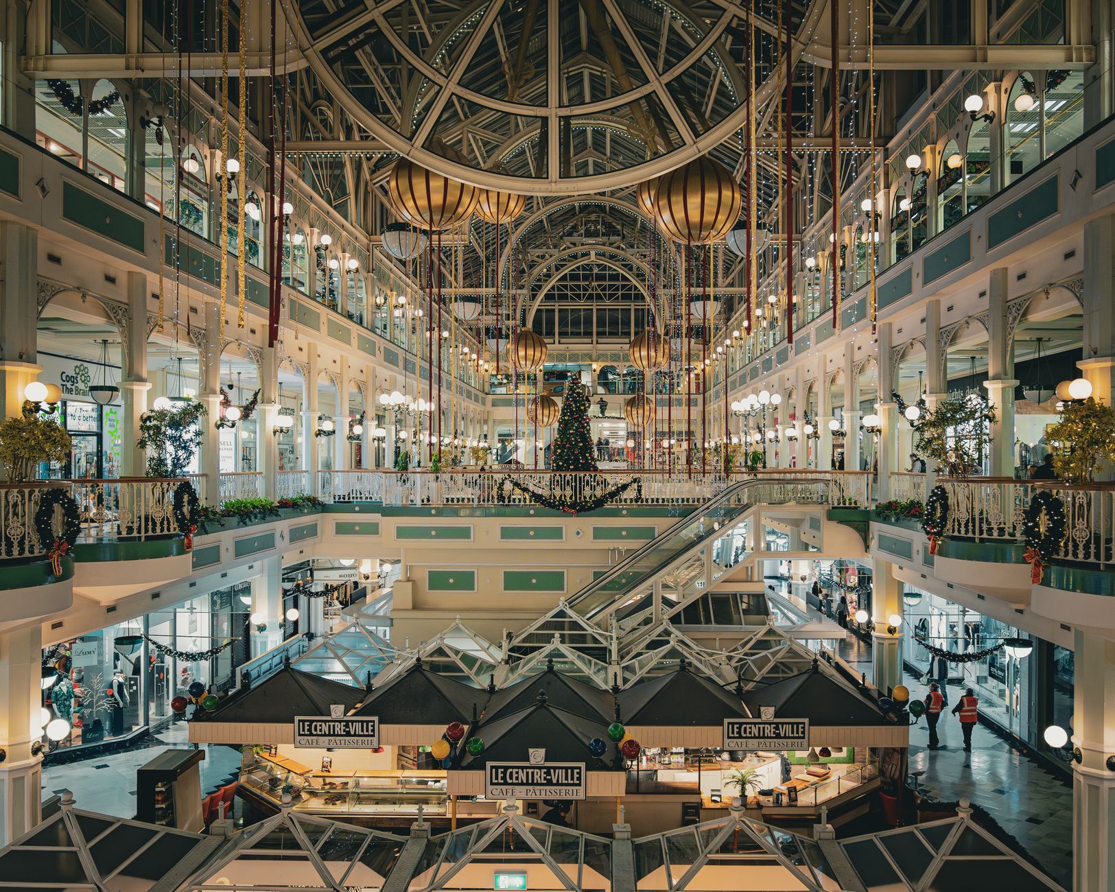 St Stephen's Green Shopping Centre in Dublin decorated for Christmas, a tall tree under the white iron galleries and glass roof